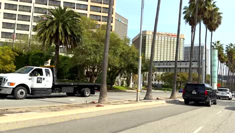 POV-Driving-down-sunny-Century-Boulevard-thoroughfare-near-LAX-airport