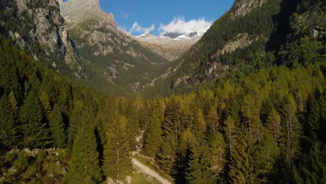Beautiful-mountain-aerial-landscape-in-Val-di-Mello-valley-forest,-forward