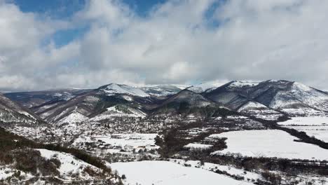 Winter-aerial-footage-of-The-Balkan-mountains-and-Bunovo,-a-village-in-Bulgaria