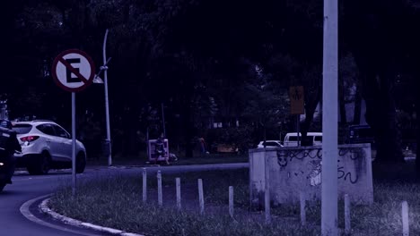 Cars-driving-on-road-turn-in-Brazil-in-slow-motion,-desaturated-gloomy-mysterious-filter-effect