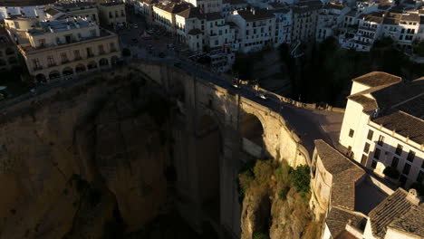 Puente-Nuevo-And-Buildings-In-Ronda,-Malaga-Province,-Spain-At-Sunset---aerial-drone-shot