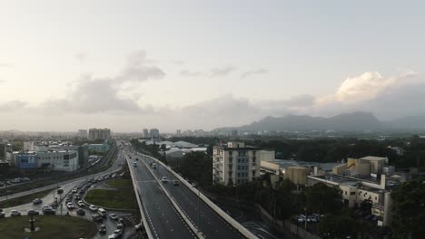 Aerial-wide-shot-showing-traffic-on-highway-in-Vacoas-Phoenix-during-rainy-day,-Mauritius