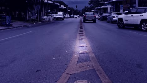 Cars-driving-on-street-in-Brazil-in-slow-motion,-blue-tint-filter-effect