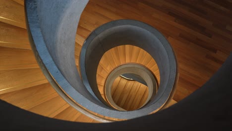 People-walk-in-iconic-staircase-at-Tai-Kwun-in-Hong-Kong,-from-above