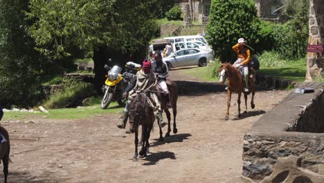 old-and-new:-Lesotho-African-family-herd-mules-through-modern-town