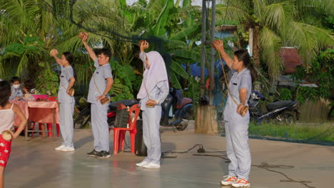 Street-performers-leading-exercise-routine-with-a-group-of-people-in-Thailand