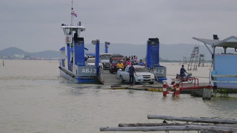 Cars,-motorcycles-and-people-exiting-the-ferry-in-Asia