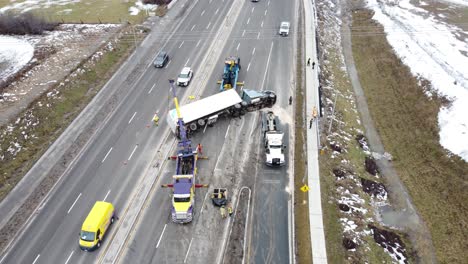A-rollover-truck-on-the-road-and-towing-truck-helping