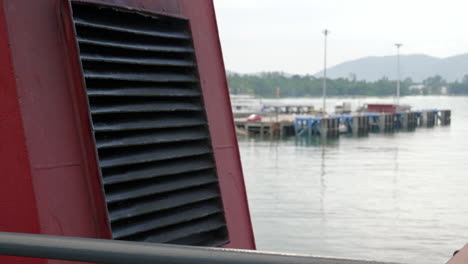 Red-vent-of-ferry-with-view-of-southeast-asia-pier-and-coast-in-baclground