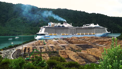 Static-view-of-cruise-ship-docked-and-large-cargo-of-lumber-on-the-quay