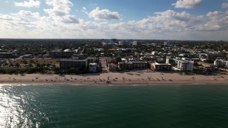 An-aerial-view-over-the-Atlantic-Ocean-facing-Fort-Lauderdale,-Florida-on-a-beautiful-day-with-blue-skies-and-white-clouds