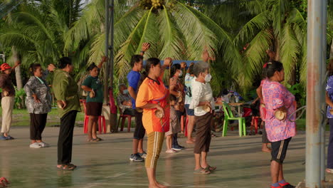 Group-of-people-exercising-on-the-street-in-Asia,-adult-and-senior-workout