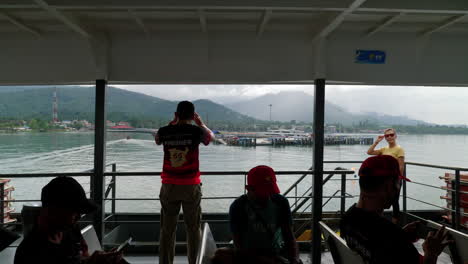 Tourists-and-travelers-photograph-and-find-seats,-ferry-departs-harbor