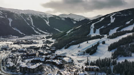 backwards-drone-tilt-shot-of-a-wintersport-village-at-the-Copper-Mountain-in-winter