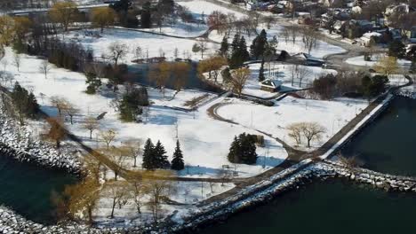 Aerial-view-of-a-Mississauga-park-covered-in-snow-on-Lake-Ontario