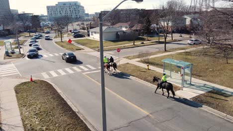 Mounted-police-officers-marching-on-the-road-on-horses
