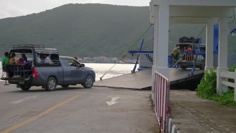 Cars-driving-on-the-ramp-to-the-ferry-boat-in-Thailand,-close-up