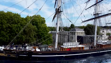 Aerial-shot-of-the-ship-Cutty-Sark-and-it's-mast,-tourists-on-the-boat,-London,-United-Kingdom