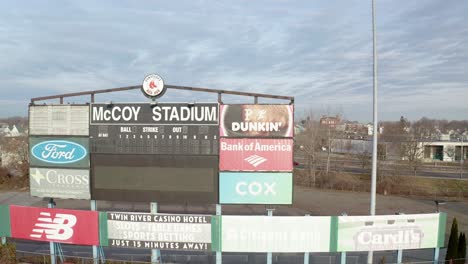 McCoy-Stadium-in-Pawtucket-Rhode-Island,-medium-drone-panning-shot-of-scoreboard-of-abandoned-stadium,-aerial