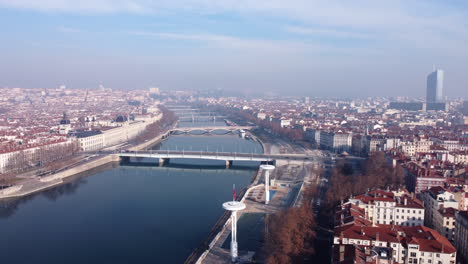 Aerial-flying-over-center-of-Lyon-next-to-river-on-sunny-day,-France