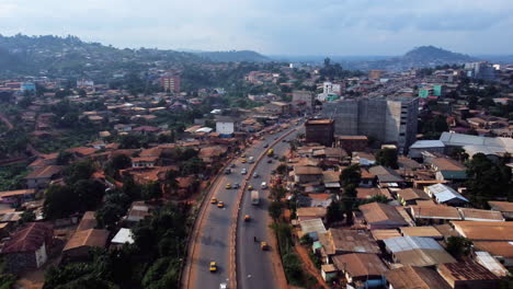 Aerial-view-of-traffic-in-the-Etoug-Ebe-district,-in-sunny-Cameroon---reverse,-drone-shot