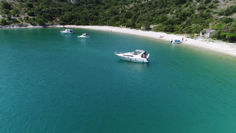 Aerial-Panoramic-View-of-European-Summer-Pula-Beach-in-Croatia,-Sea-Coastline-of-Blue-Water-and-Calm-Atmosphere,-People-Sailing-and-Sunbathing