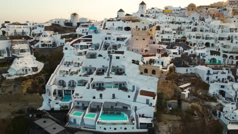 Aerial-View-of-Luxury-Resort-on-Santorini-Island,-Greece,-White-Buildings-and-Private-Swimming-Pools