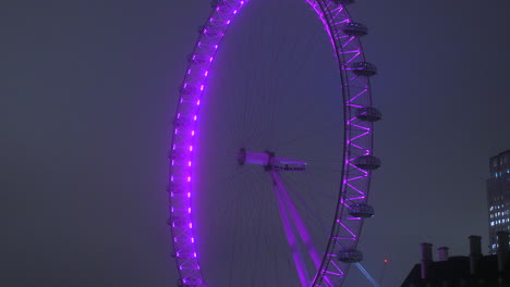 Illuminated-London-Eye-At-Thames-River-During-Nighttime-In-London,-United-Kingdom