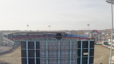 McCoy-Stadium-in-Pawtucket-Rhode-Island,-drone-rising-over-scoreboard-to-reveal-the-abandoned-baseball-field,-aerial