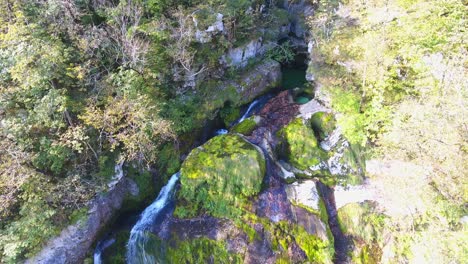 Aerial-View-Above-Virje-Waterfall,-Bovec,-Slovenia-Water-Stream-Between-Mountain-Green-Alps-Landscape,-Travel-Destination-in-Wild-Forest