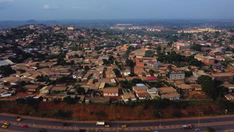 Road-and-African-houses-in-the-Emanna-district-of-Yaounde,-Cameroon---Aerial-view