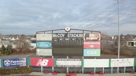 McCoy-Stadium-in-Pawtucket-Rhode-Island,-revealing-drone-shot-starting-on-scoreboard-of-abandoned-stadium,-aerial