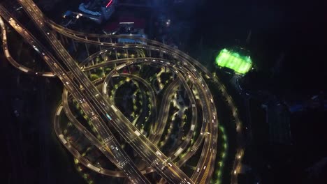 Aerial-shot-of-circular-roads-and-highways-floating-five-levels-exchange-in-Chongqing-and-cars-driving-on-them-on-the-night
