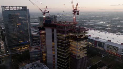 Aerial-view-overlooking-the-Skanska-high-rise-project-site,-clear-morning-in-Houston,-USA---rising,-drone-shot