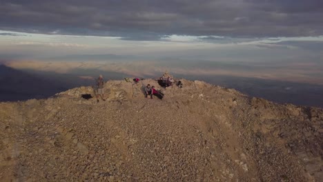 HIKERS-ON-TOP-OF-MT-NEBO-UTAH-ACCOMPLISHMENT-MORNING-LIGHT-GOLDEN-HOUR---AERIAL-DOLLY-RISE