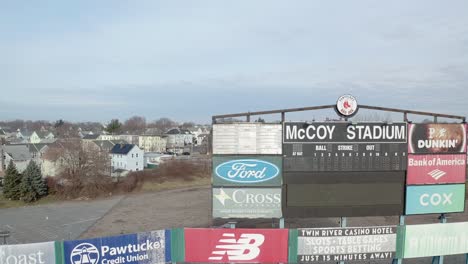 McCoy-Stadium-in-Pawtucket-Rhode-Island,-tight-drone-shot-of-scoreboard-of-abandoned-stadium,-aerial