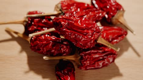 close-up-of-a-pile-of-dried-hot-peppers-lying-on-a-wooden-table