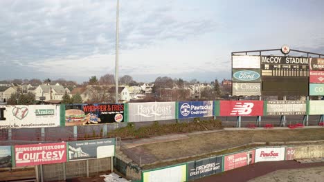 McCoy-Stadium-in-Pawtucket-Rhode-Island,-panning-drone-shot-of-scoreboard-at-abandoned-stadium,-aerial