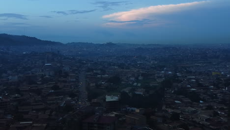 Drone-overview-of-the-cityscape-of-Etoug-Ebe,-blue-hour-in-Yaounde,-Cameroon,-Africa