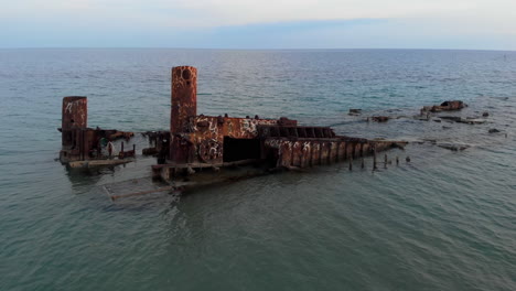 Drone-Video-passing-over-shipwreck-Blue-sea-waters-top-down-view