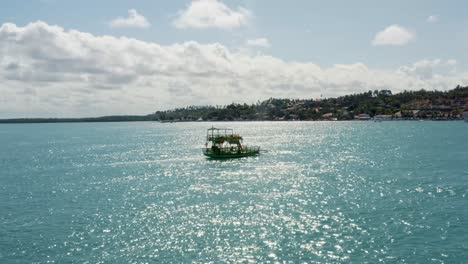 Rotierende-Luftdrohnenaufnahme,-Die-Einem-Kleinen-Transportboot-Folgt,-Das-Auf-Einem-Tropischen-Türkisfarbenen-Fluss-Vom-Restinga-Strand-Zum-Barra-Do-Cunhaú-Strand-In-Rio-Grande-Do-Norte,-Brasilien,-Fährt