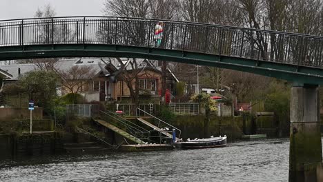 Child-crossing-the-Eel-Pie-Island-Bridge-in-Twickenham,-London,-United-Kingdom