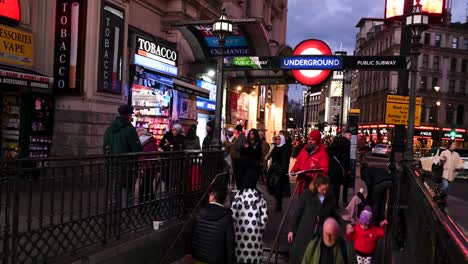 Entering-Piccadilly-Circus-Underground-Station-in-the-evening,-London,-United-Kingdom