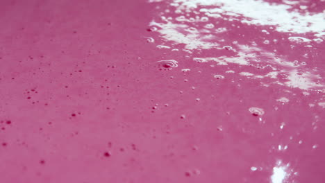 Close-up-shot-of-bubbles-popping-from-the-poured-out-milkshake-mix