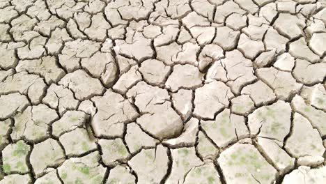 Cracked-land-because-of-drought,-aerial-ascend-view