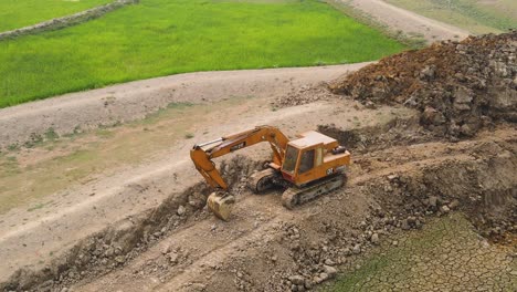 Caterpillar-industrial-excavator-bulldozer-aerial-view-on-construction-site-preparing-dirt-ground