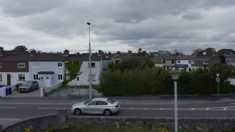 a-silver-car-drives-by-Claddagh,-in-Grattan-road,-Galway
