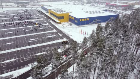 Tractors-pushing-snow-on-the-parking-lot-of-a-giant-Ikea-store