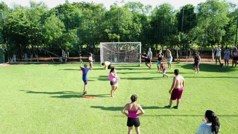Slow-Motion-Shot-Of-Kids-Playing-Soccer-On-Green-Field,-Paraguay
