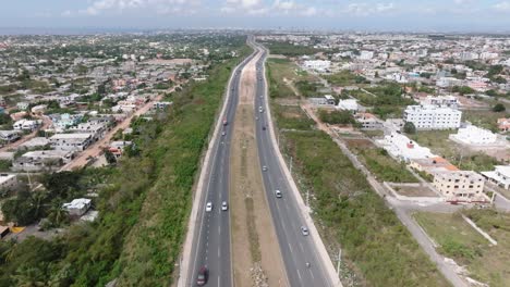Aerial-flyover-busy-ECOLOGICAL-AVENUE-in-Santo-Domingo-during-sunny-day,Dominican-Republic
